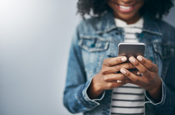 Woman looking at our dental website on her mobile phone.